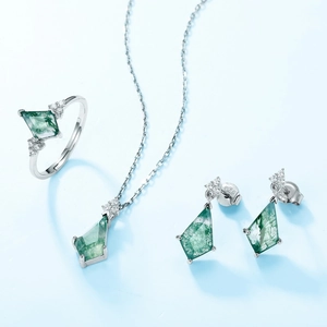 S925 silver jewelry set with kite-cut green moss agate and zircon accents on blue background