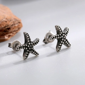 Vintage silver starfish stud earrings with textured metallic finish for ocean style