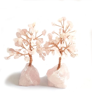Detailed close-up of a pair of handmade pink crystal money trees with copper wire branches
