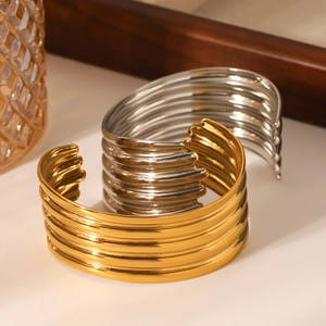 Polished layered open cuff bracelet in gold and silver finish made of stainless steel