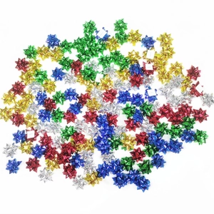 Assorted colorful metallic mini star bows for Christmas gift wrapping on white background