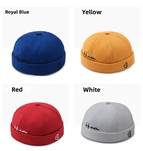 Detail view of retro sailor caps in royal blue, yellow, red, and light grey canvas