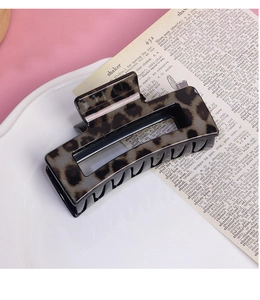 Macro shot of rectangular leopard print hair claw clip with high-gloss hollow design