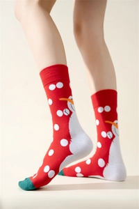 Close-up of red cotton Christmas socks with snowman patterns and green toe details