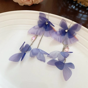 Detail of purple butterfly earrings with crystal accents and pink teardrop beads