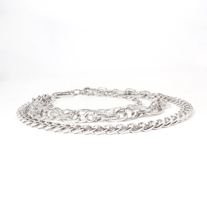 Detail of silver multi-layered heavy metal pants chain with polished cuban links and textures