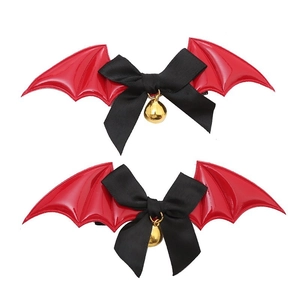 Detail of bat wing hair clips with red and black leather, bows and golden bells