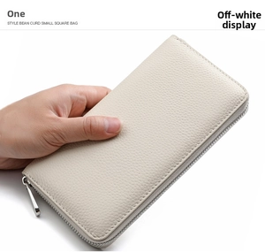 Detail of off-white leather long wallet featuring premium litchi texture and metal zipper