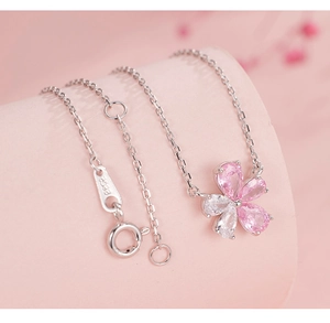 Macro view of S925 sterling silver flower necklace with pink and white zircon stones