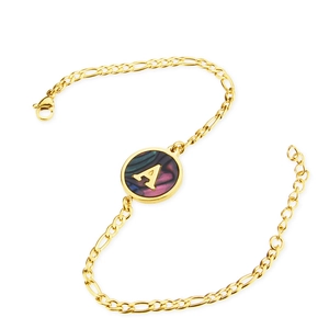 Detailed macro view of gold plated Figaro chain bracelet with shell letter A pendant