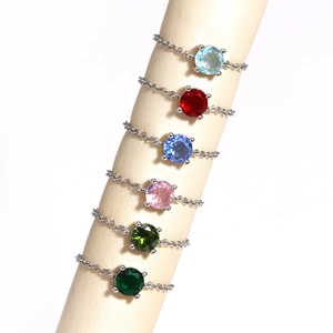 Detail of adjustable silver chain rings featuring multi-color round-cut zircon stones