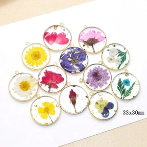 Detailed view of 33x30mm resin flower pendants with gold foil in various colors