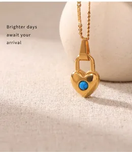Close-up of heart lock pendant necklace in 18k gold finish with blue turquoise stone
