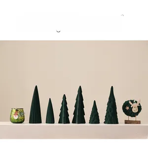 Detail of flocking ceramic Christmas tree set with reindeer ornament on minimalist shelf