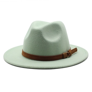 Detail of mint green wool fedora with brown leather band and gold buckle accent