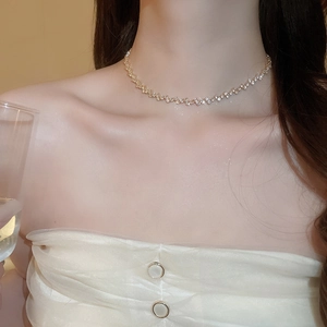 Close-up of elegant gold zircon tassel necklace on model highlighting high-end texture