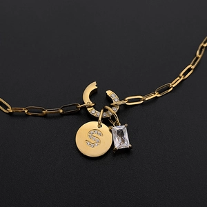 Elegant gold stainless steel necklace with crystal initial S and baguette pendant