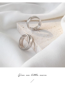 Detailed close-up of minimalist S925 sterling silver rings on natural stone