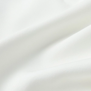 Macro shot of high-quality white textile fabric with fine weave and soft shadow folds