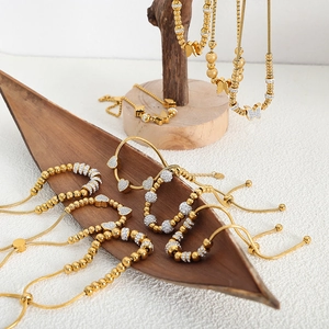 Parure collier et bracelet en billes dorées avec pendentifs cœur et papillon en zircon