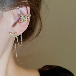Detailed view of a gold-plated butterfly ear cuff and drop earring with cubic zirconia
