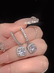 Macro view of S925 sterling silver square hoop earrings with sparkling pavé diamonds