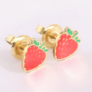 Macro shot of strawberry stud earrings showing the steel hallmark on the gold backing