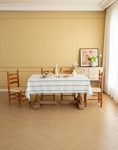 Close-up of green American vintage tablecloth with white stripes and elegant fringe
