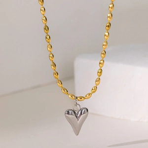 Golden beaded necklace featuring a sleek silver 3D heart-shaped pendant for women