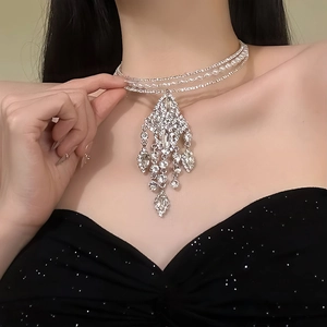 Luxurious tiered choker with crystal tassels and pearls worn for a sophisticated evening look