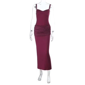 Detail of burgundy evening dress featuring intricate lace patchwork at the waistline