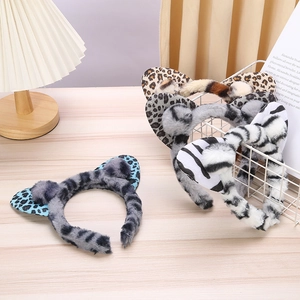 Detailed macro of various plush animal ear headbands with leopard and tiger patterns
