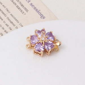 Macro view of rose gold flower clasp with purple heart zircons for jewelry making