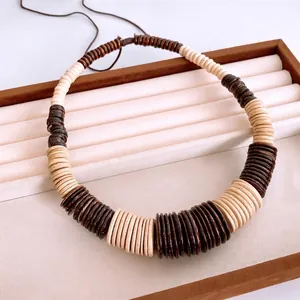 Bohemian retro ethnic necklace with coconut shell and wooden beads on a display tray