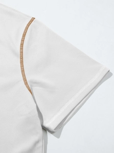 Macro shot of white breathable waffle knit polo shirt with brown stitching details