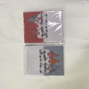 Detail of Christmas wine bottle bags featuring gnome prints and red burlap fabric