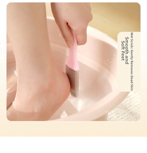 Close-up of pink handheld foot scrubber removing dead skin from heel in water