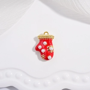 Festive red Christmas stocking pendant with pearls on a decorative white tray background