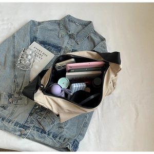 Flat lay of a beige large tote bag showing capacity for tablets and umbrellas