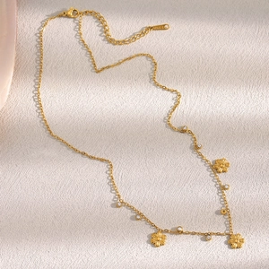 Detailed view of gold plated stainless steel necklace with zircon flower charms