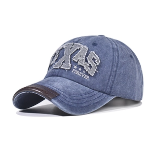 Close-up of vintage washed denim TEXAS FOREVER embroidery and leather brim detail