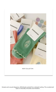 Detail of colorful combed cotton socks with delicate tulip embroidery and ribbed texture