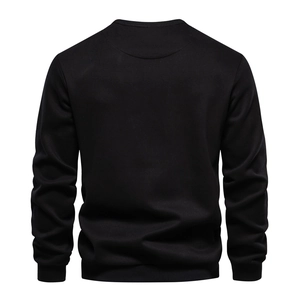 Detailed back view of a black crewneck sweatshirt showing stitching and ribbed cuffs