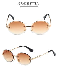 Detail of rimless oval sunglasses with gradient tea lenses and sleek gold metal temples