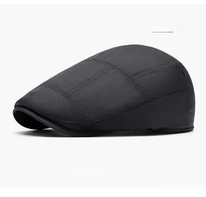 Detailed view of the gray plaid texture and fine stitching on a vintage flat cap