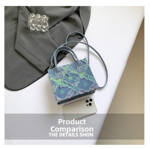 Detailed macro of a blue denim mini tote with green star print and frayed edges