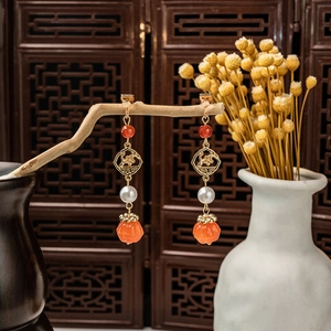 New Chinese vintage beaded earrings with pearls and long orange tassels on wooden stand