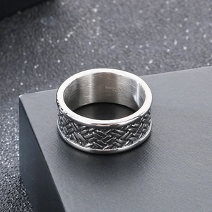 Macro detail showing woven texture and 316L stainless steel engraving on vintage silver ring
