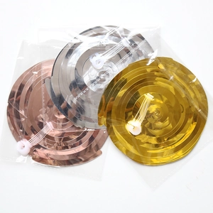 Detailed view of spiral hanging decorations in gold, silver, and rose gold foil packaging
