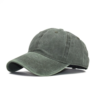Side view detail of washed cotton baseball cap with vintage finish and curved brim